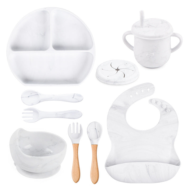 Collection of white baby feeding utensils and accessories on a white background