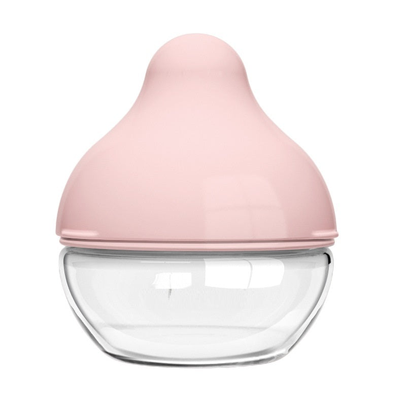 Pink baby bottle nipple with clear container on a white background