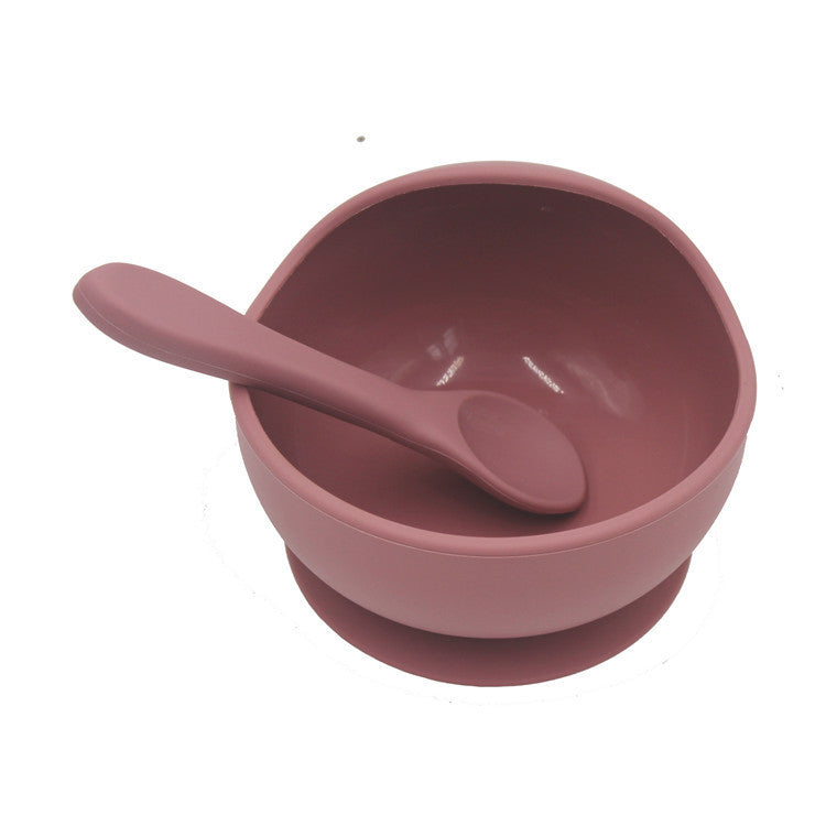 Pink bowl and spoon set on a white background