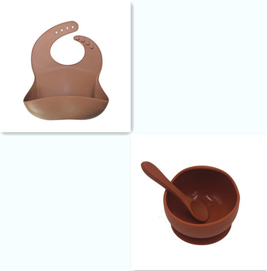 Set of brown baby bib, bowl, and spoon on a white background