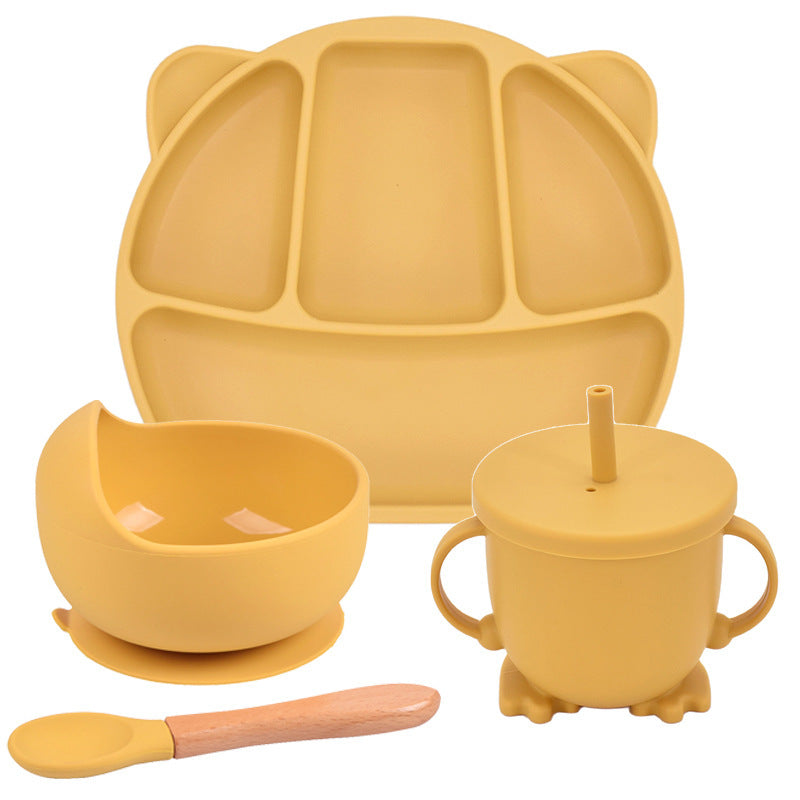 Yellow silicone dining set with plate, bowl, cup, and spoon on a white background