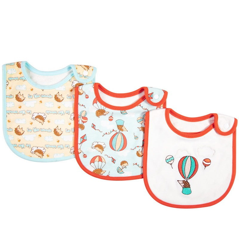 Three baby bibs with different patterns on a white background