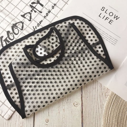 Black and white polka dot face mask on a newspaper with 'Good Day' and 'Slow Life' text.