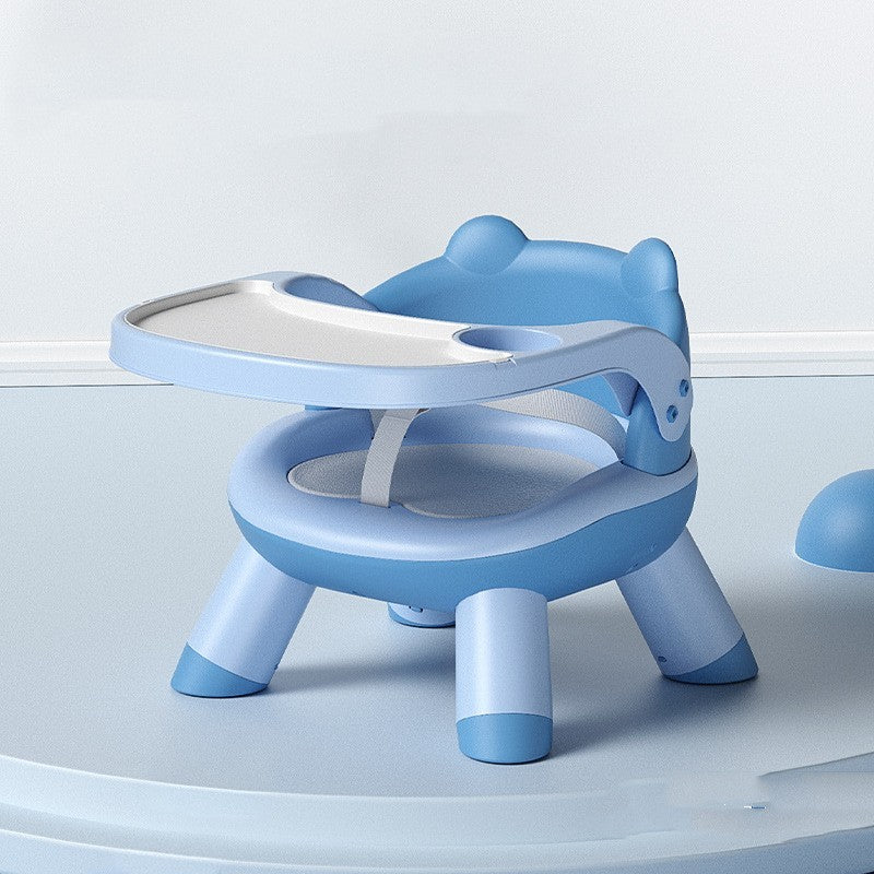 Blue children's seat with tray on a light gray background