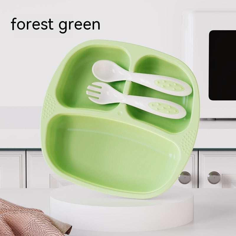 Green divided plate with utensils on a white background