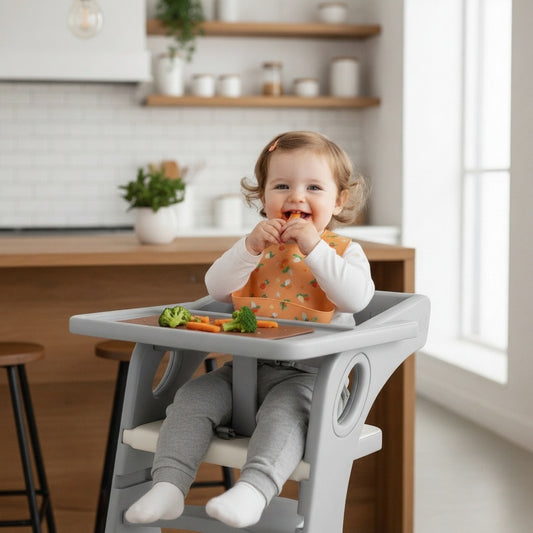 Child sitting in a high chair eating vegetables in a kitchen