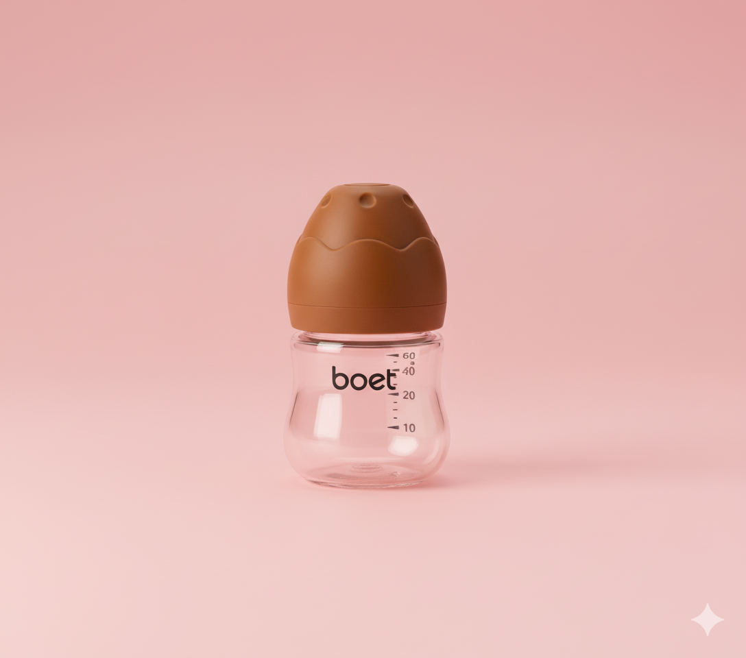 Baby bottle with brown cap on a pink background