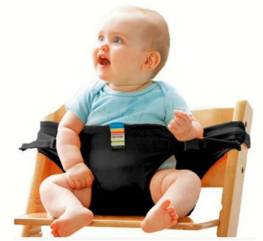 Baby sitting on a wooden chair with a black baby seat