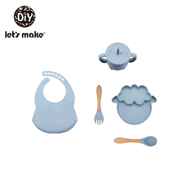Baby utensils set with bib, teapot, fork, and spoon on a white background, featuring 'let's make' brand.