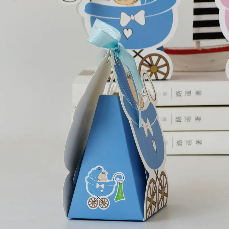 Blue baby shower favor box with a ribbon on a white surface