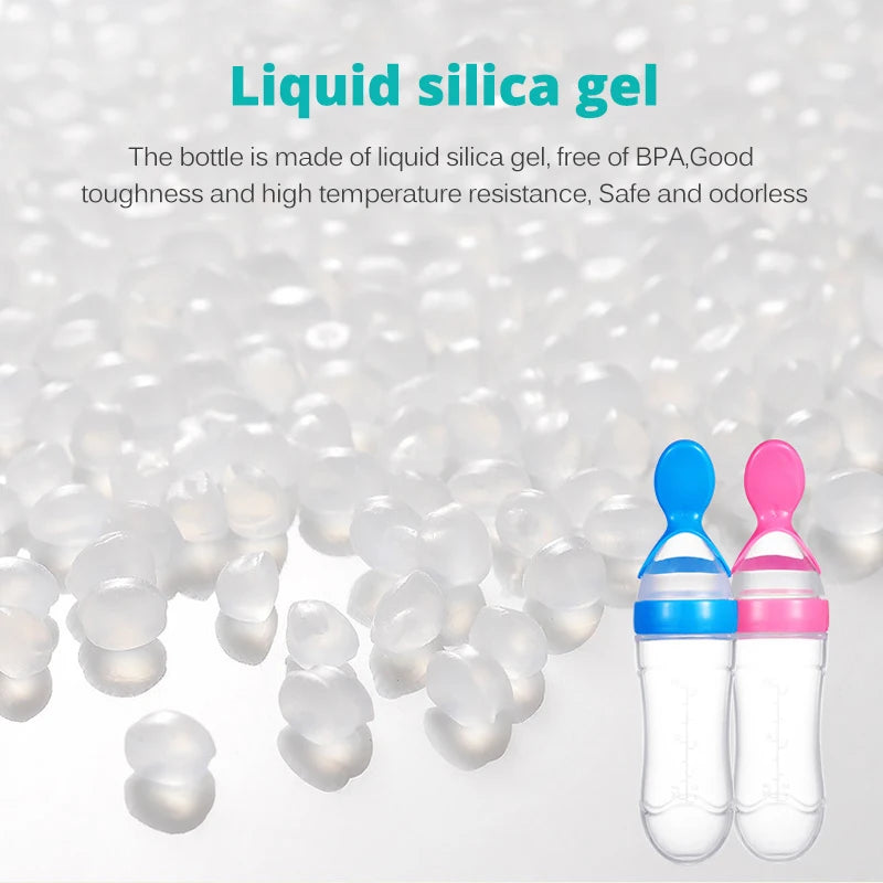 Two baby bottles with blue and pink caps on a white background with liquid silica gel beads.