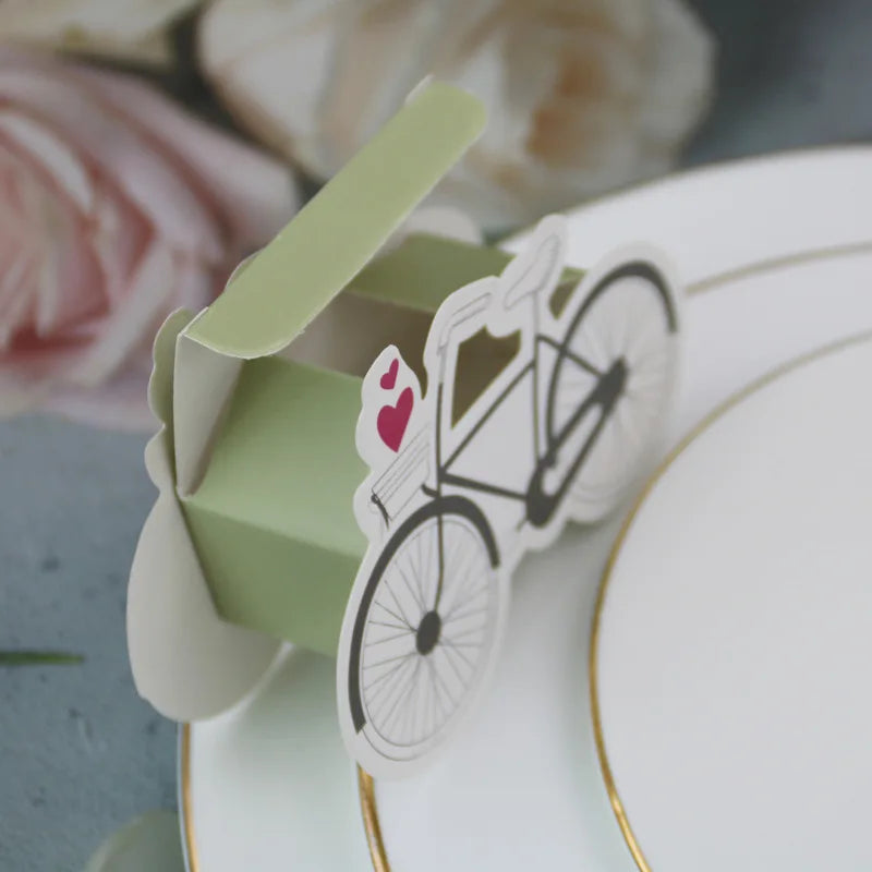 Card with bicycle design on a decorative plate with flowers in the background