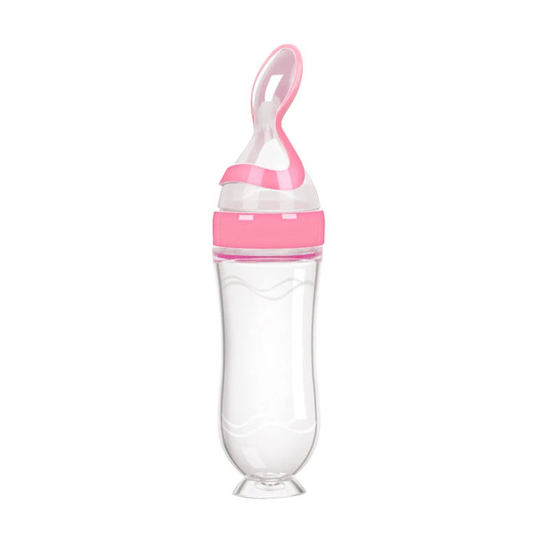 Pink and clear baby feeder on a white background