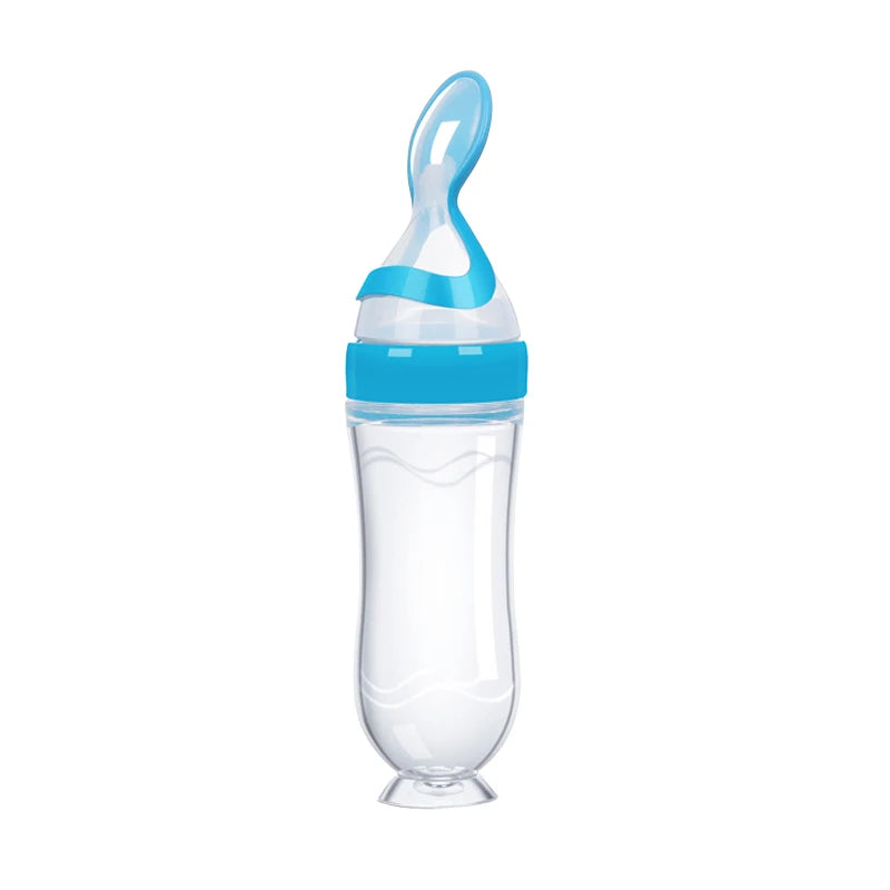 Clear baby bottle with blue cap on a white background