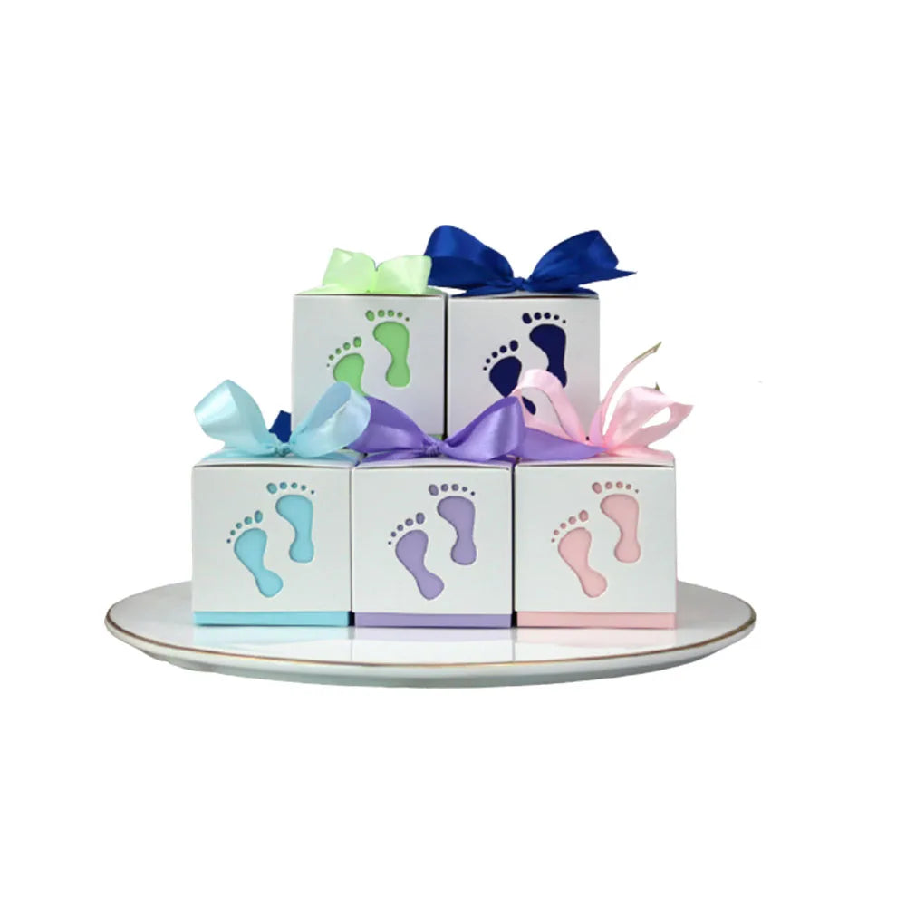 Decorative baby blocks with footprints and colorful bows on a white background