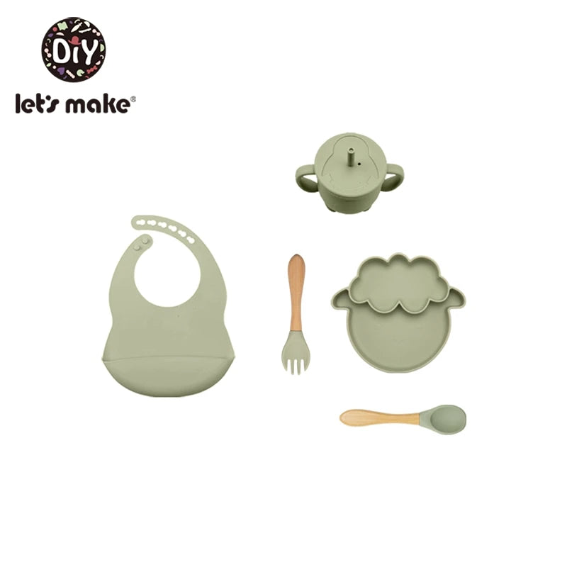 Set of green baby utensils including a bib, plate, fork, and spoon on a white background with 'let's make' branding.