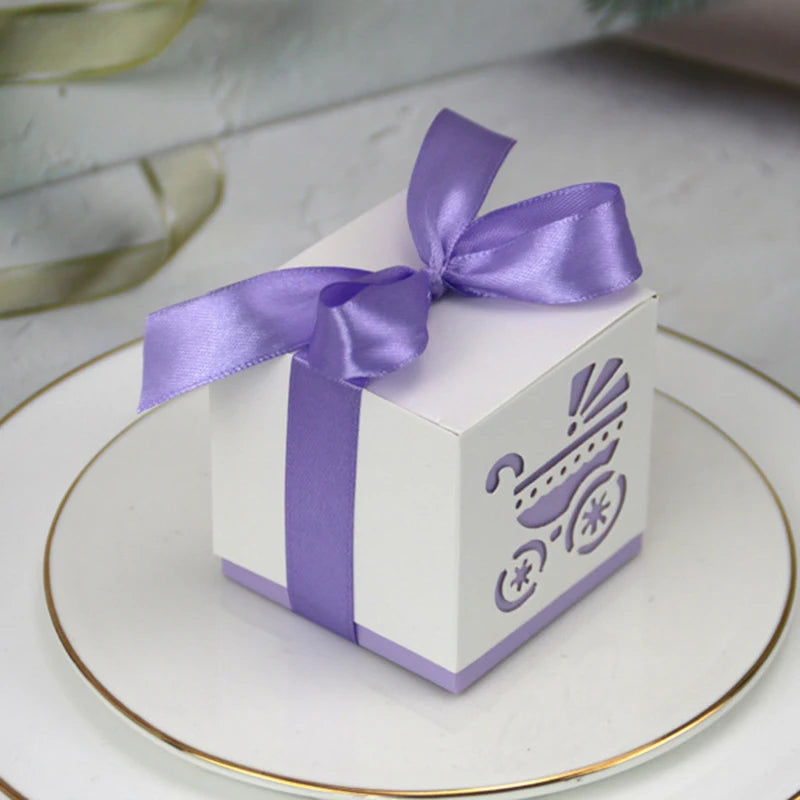 White gift box with a purple ribbon on a white plate