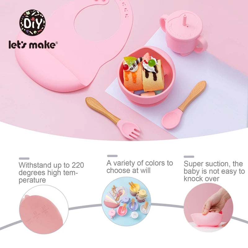 Children's tableware set with pink bowl, cup, and utensils on a pink background.