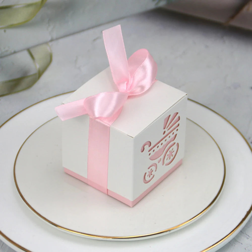 White gift box with pink ribbon on a white plate