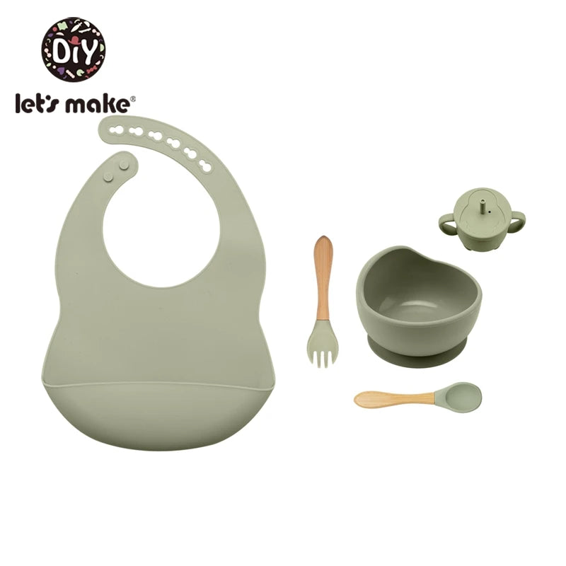 Baby feeding set with bib, bowl, spoon, and fork on a white background, featuring 'let's make' brand.