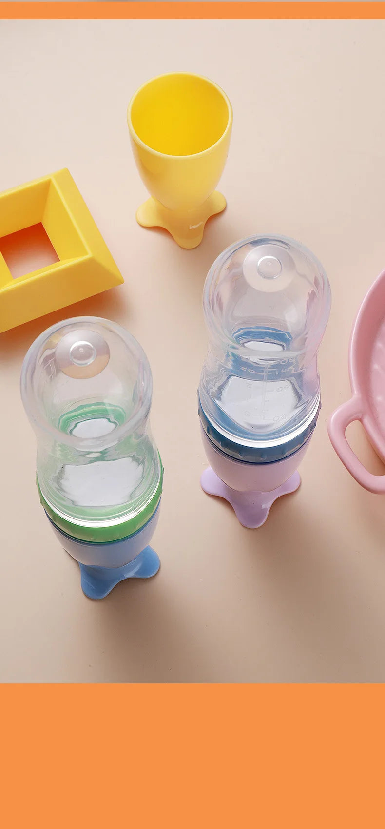 Colorful baby feeding and teething products on a beige surface