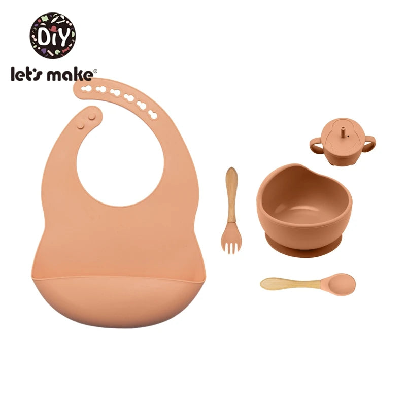 Baby feeding set with bib, bowl, spoon, and cup on a white background, featuring 'let's make' brand.