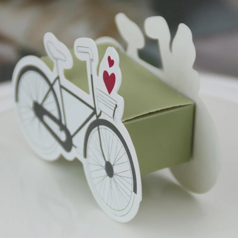 Green box with a bicycle and heart design on a white surface