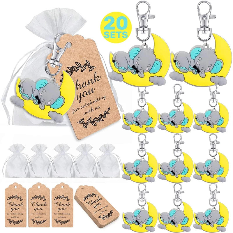 Set of keychains with elephant design, tags, and a drawstring bag on a white background