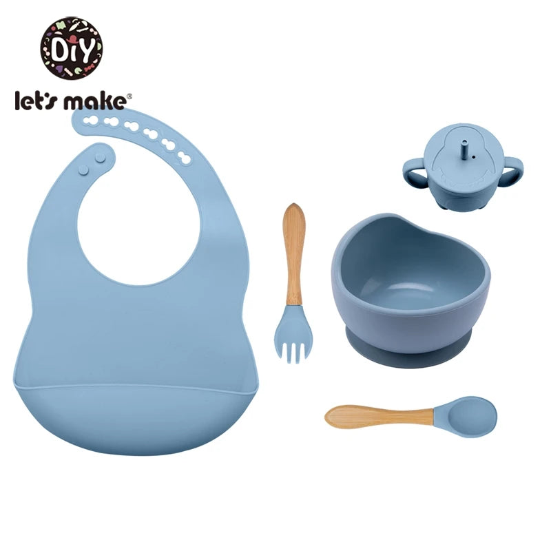 Baby feeding set with bib, bowl, spoon, and fork on a white background, featuring 'let's make' brand.