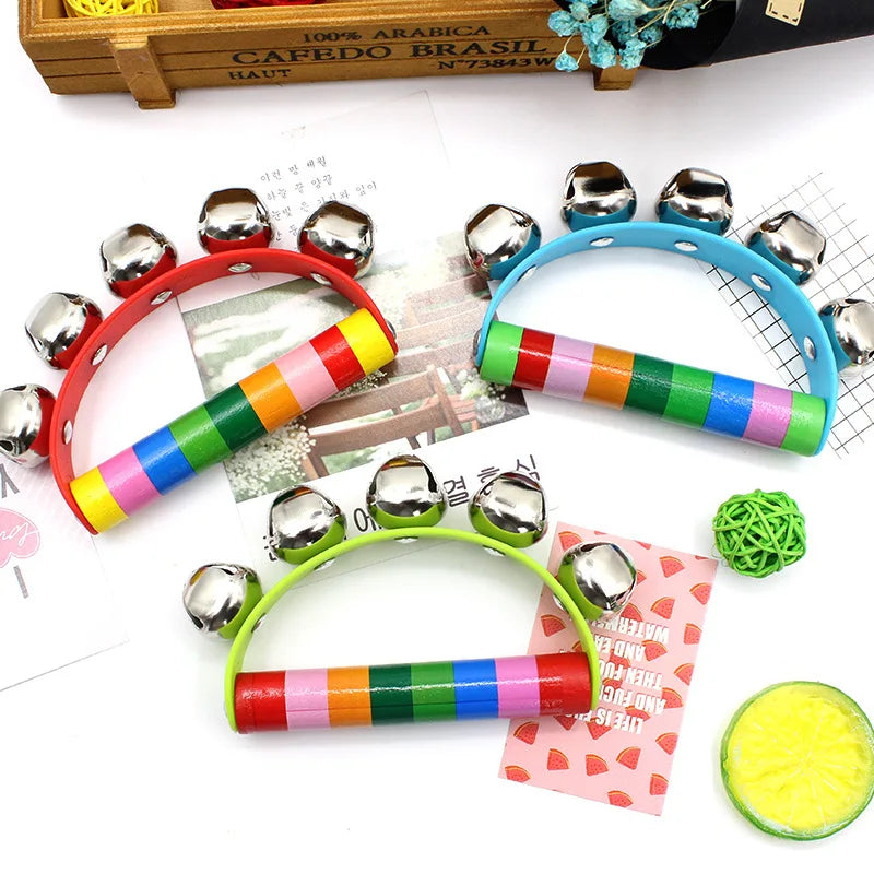 Colorful children's tambourines with jingle bells on a white surface.