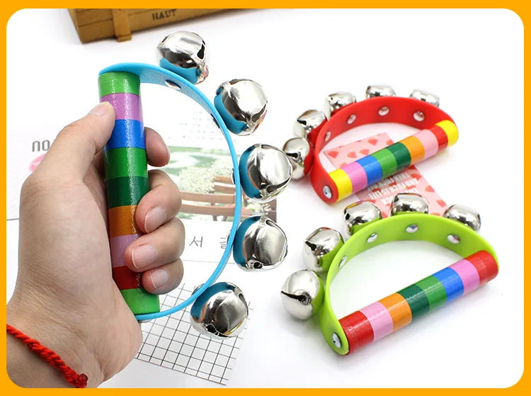 Colorful handbell toy held by a hand with a blurred background