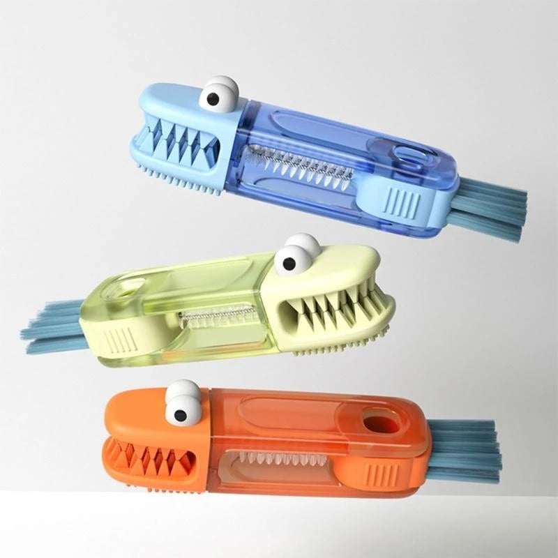 Three colorful alligator-shaped cleaning brushes on a light gray background