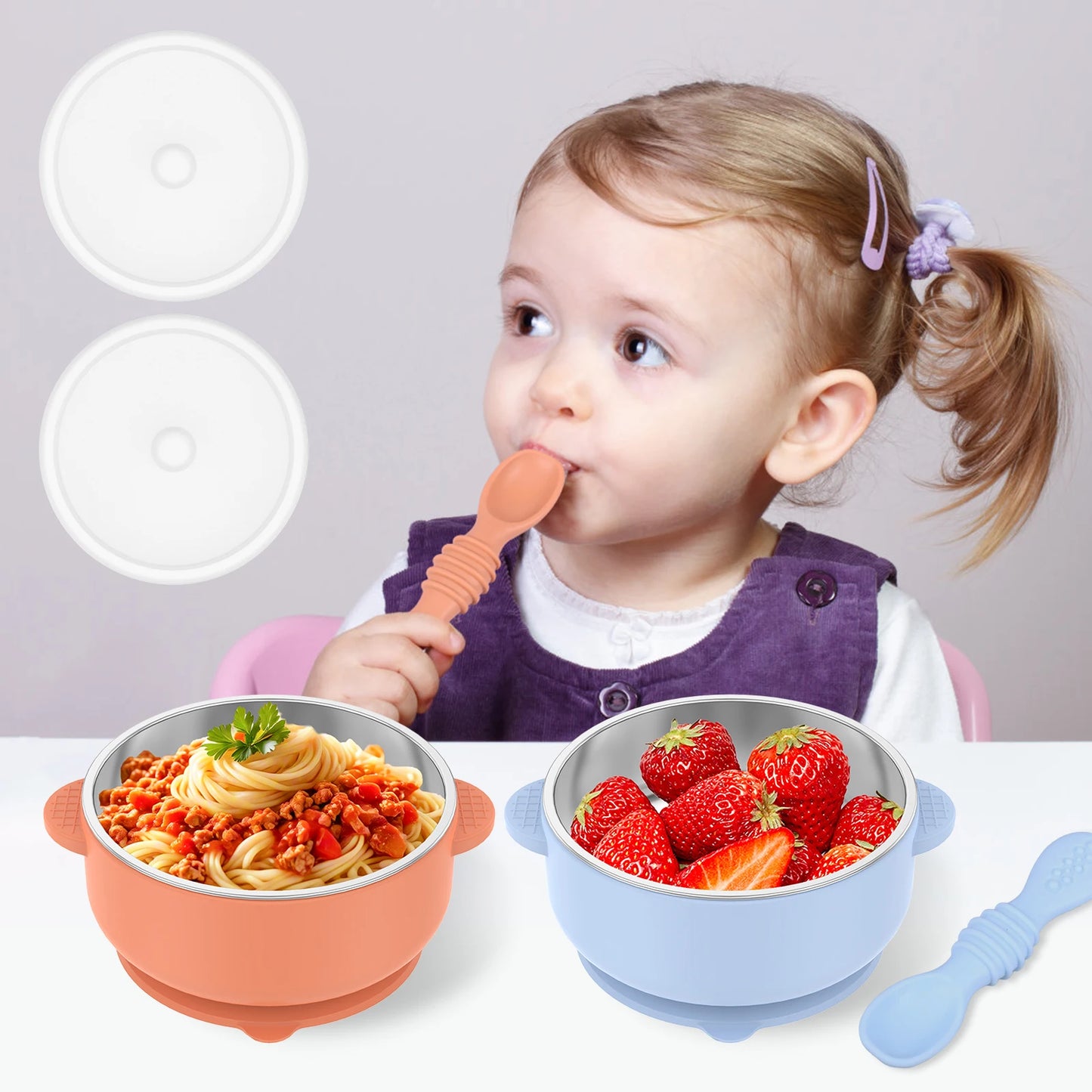 Child eating from a bowl of spaghetti with two additional bowls and a spoon on a white background