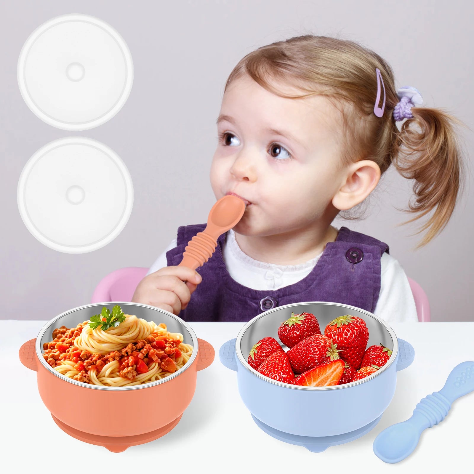 Child eating from a bowl of spaghetti with two additional bowls and a spoon on a white background