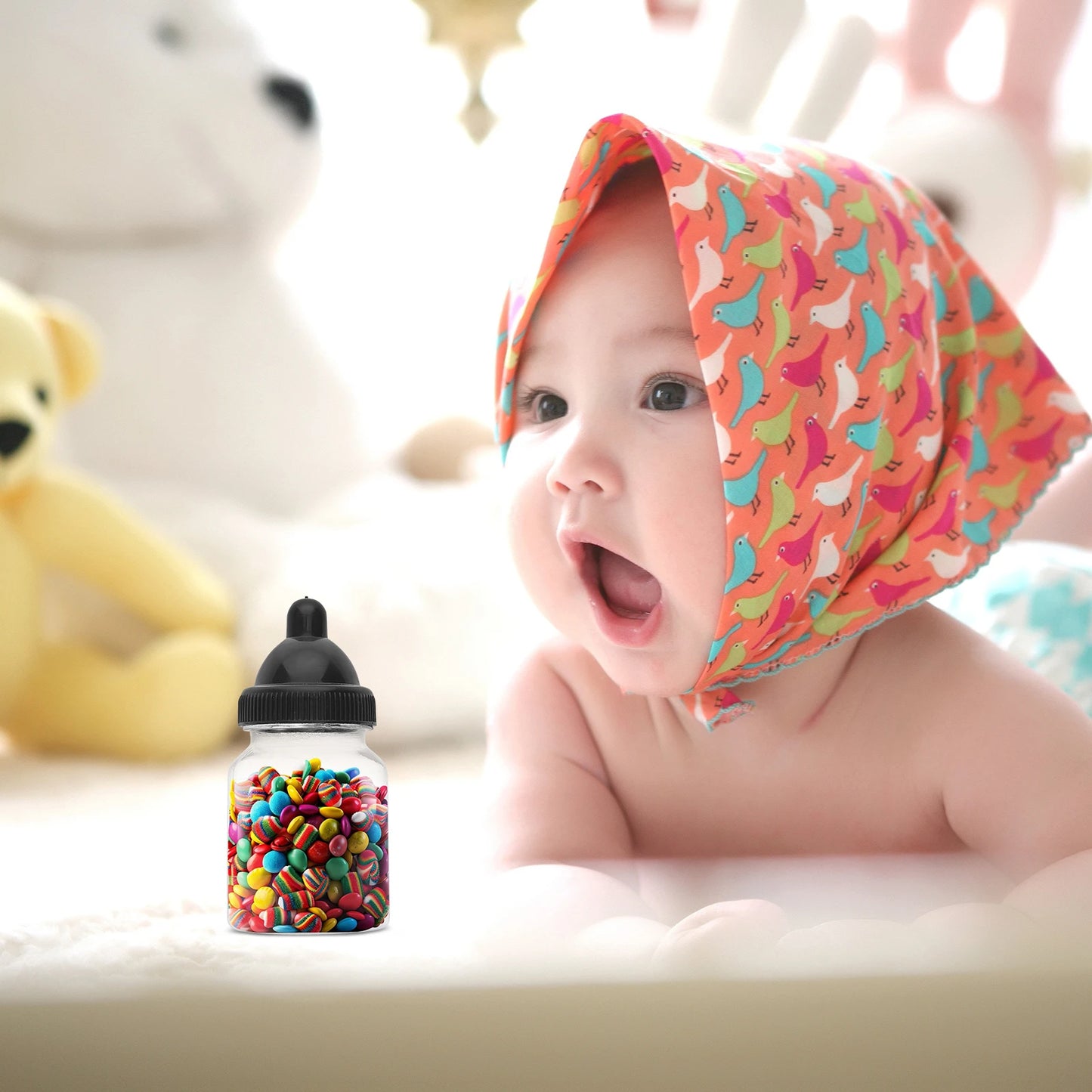 Baby wearing a colorful headscarf with toys in the background