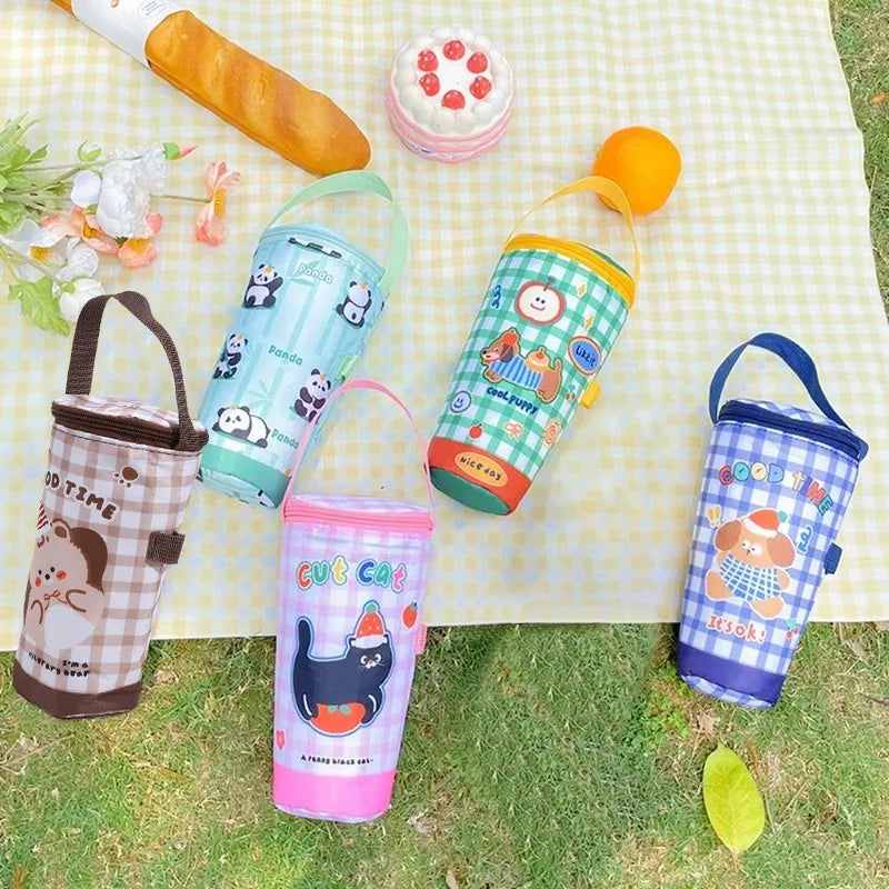 Colorful water bottles with cartoon designs on a checkered blanket