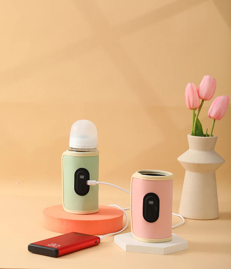 Two small electronic devices on stands with a vase of pink tulips on a beige background