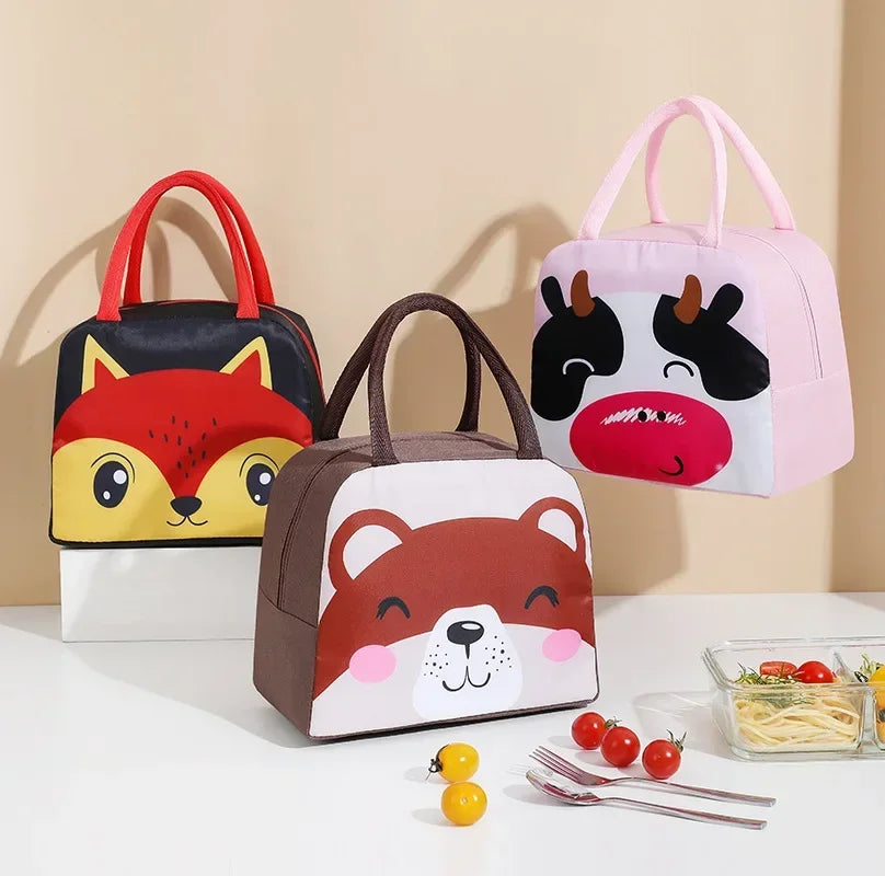 Three animal-themed lunch bags on a white surface with a beige background