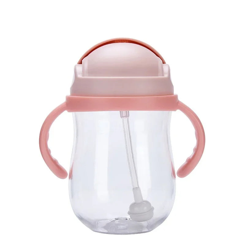 Clear sippy cup with pink handles and lid on a white background