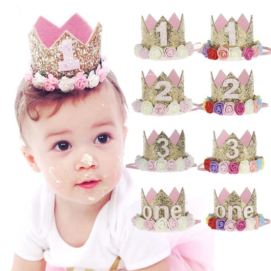 Baby wearing a birthday crown with numbers and flowers, surrounded by similar crowns.