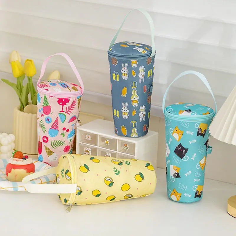 Four colorful water bottles with patterned covers on a white surface.