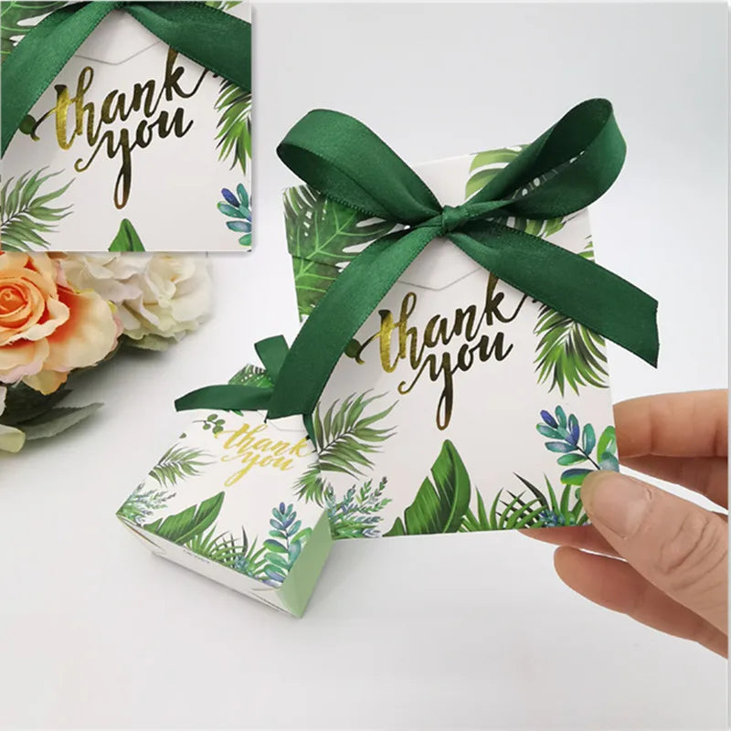 Gift box with green ribbon and 'thank you' card on a white background