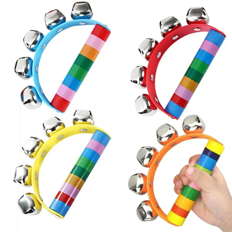 Colorful children's handbells with a hand holding one of them on a white background