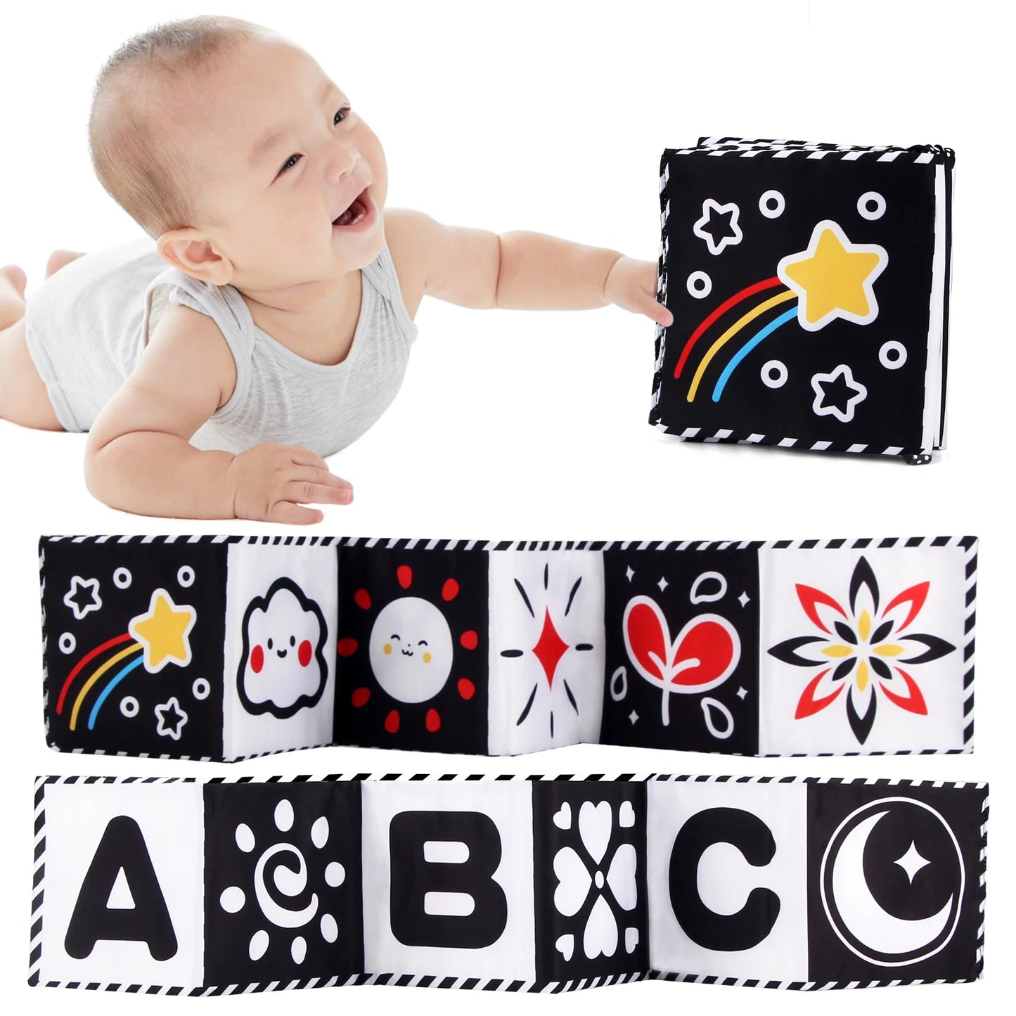 Baby playing with a soft book featuring black and white patterns and colorful letters.