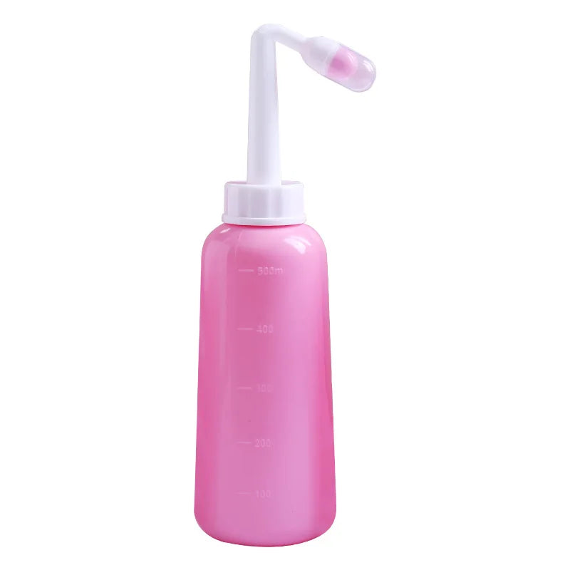 Pink nasal aspirator bottle with white nozzle on a white background