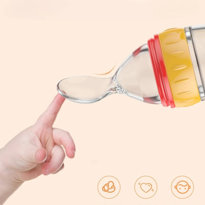 Hand holding a spoon with a container of baby food against a beige background