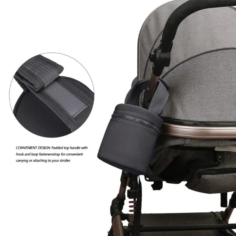 Gray stroller with a padded top handle and hook and loop fastener strap on a white background.