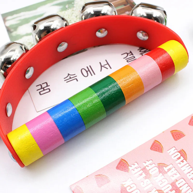 Colorful wooden toy with metal jingles on a white background