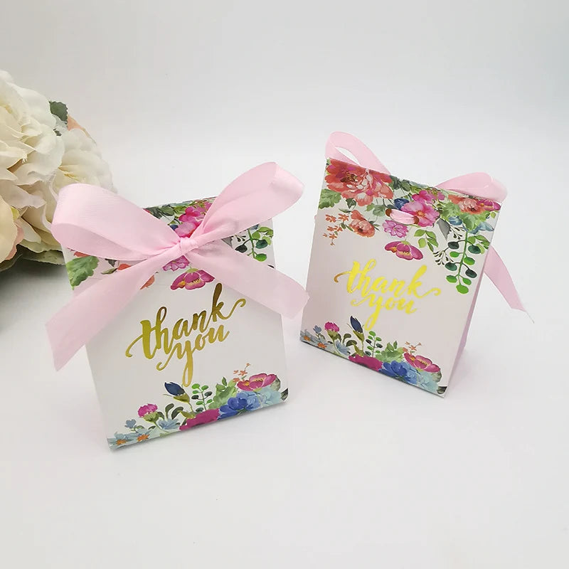 Two floral gift boxes with 'thank you' text and pink ribbons on a white background.