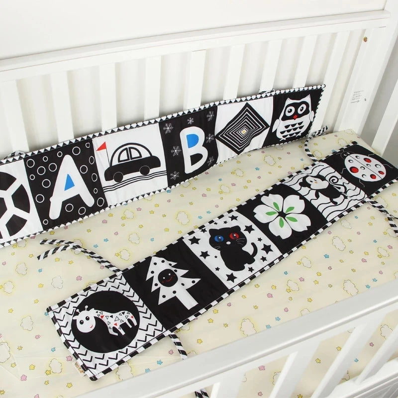 Crib bumper with black and white patterns on a crib